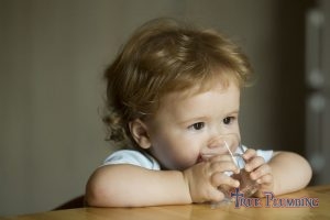 A Child Drinks Water.