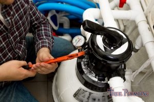 A Plumber Repairs a Water Heater.
